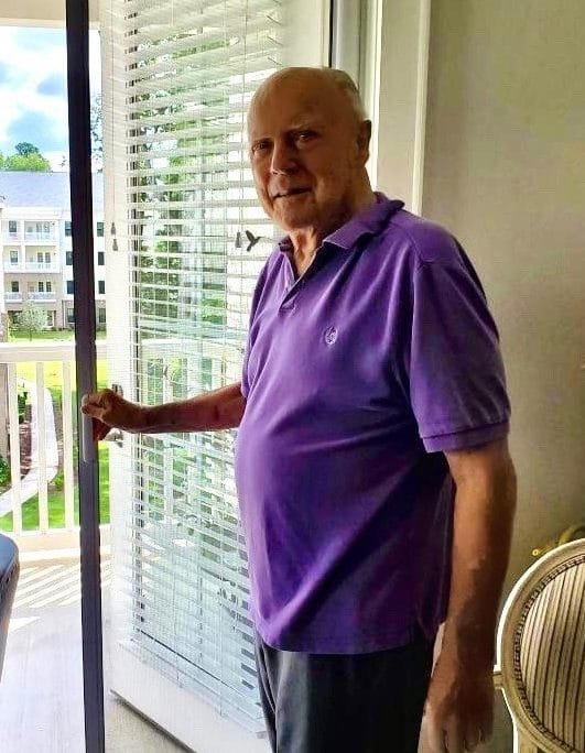 Male walking out on a balcony