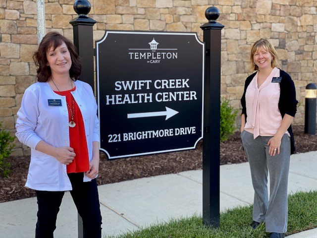 2 women by Swift Creek Sign