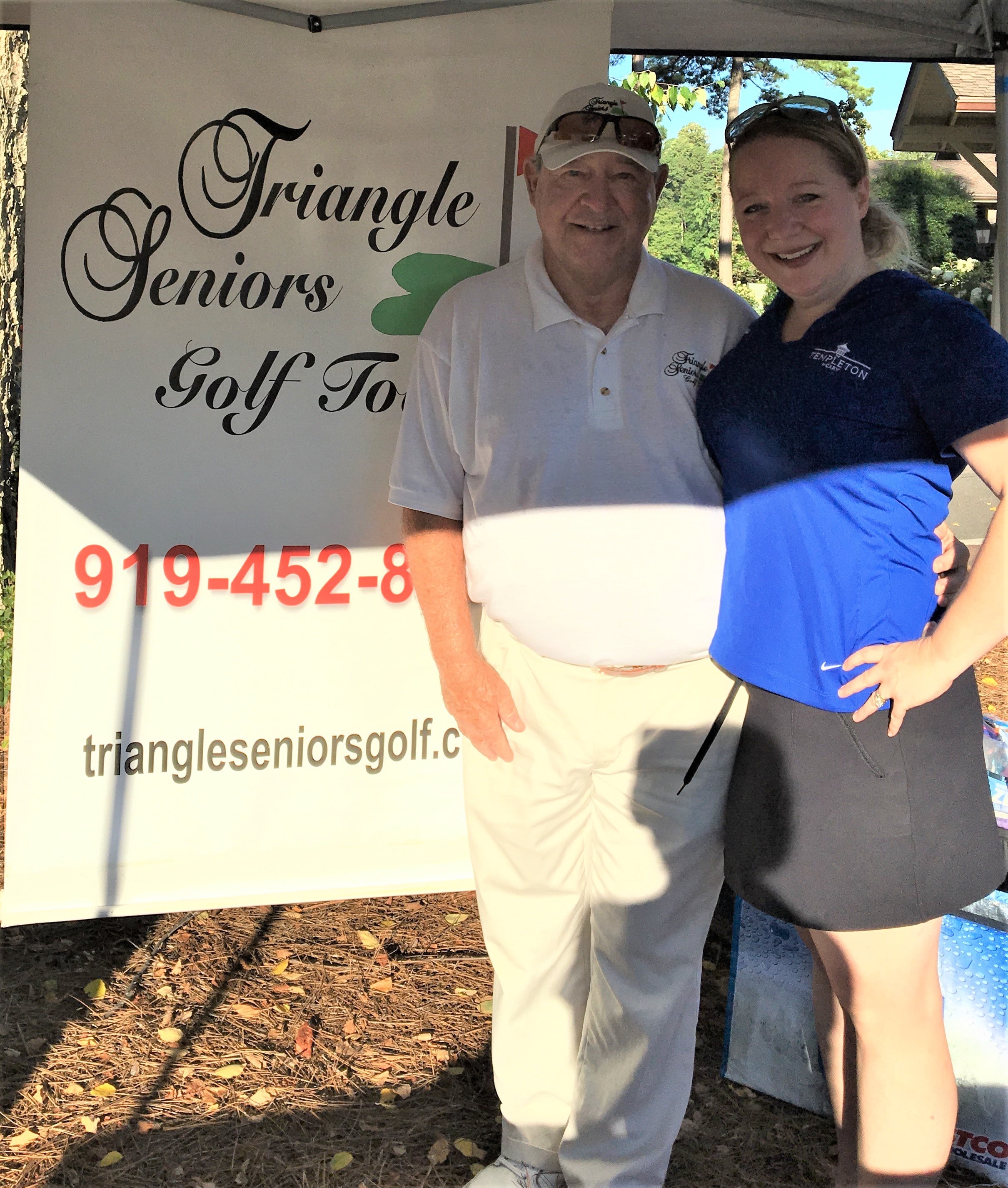 templeton sales staff female standing beside male golfer